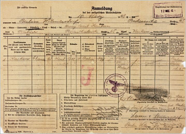 A police form stamped with a red letter J for Jude, that registers the residence of the Jewish child